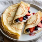Thin, tender homemade healthy crepes served with fresh berries, yogurt, and savory fillings.